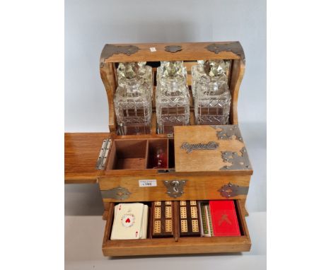 Victorian pale oak three section tantalus, comprising three hobnail cut decanters and stoppers. The tantalus marked 'Cigars' 