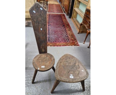 Welsh carved beech high backed spinning chair, together with similar companion stool, both decorated with Welsh Dragons. (2) 