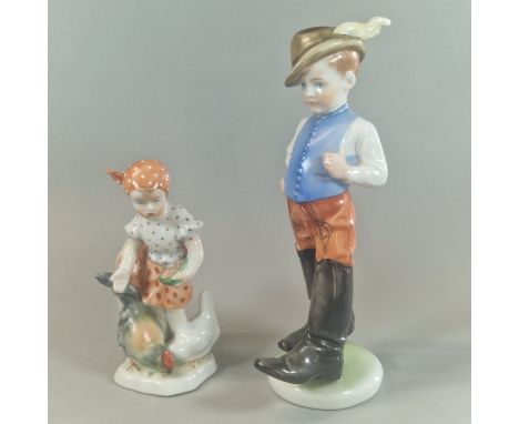 Herend Hungary hand-painted figure of a boy in feathered brown hat and black boots with blue waistcoat. 22cm high approx. Tog