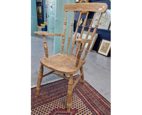 Early 20th century beech and elm bleached stick backed fireside elbow chair. (B.P. 21% + VAT). Bleached condition. A little u