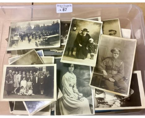 Collection of old black and white photographs and few postcards in plastic box, portrait, family groups, military, etc. (B.P.