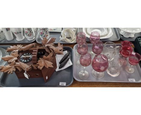 Modern carved and wooden cuckoo clock with cone shaped weights, together with a tray of various drinking glasses: etched tank