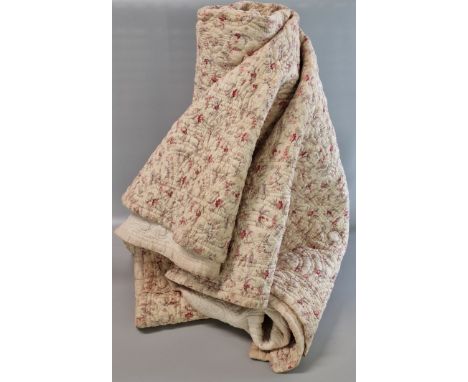 Victorian cream ground quilt, with overall repeating floral and foliate designs. Stitched to the reverse '1889' and initials 