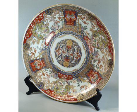 Japanese polychrome Imari style charger, painted to the front and reverse with Dragon roundels and scroll framed Ho-ho birds,
