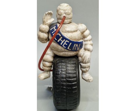 Vintage Michelin Man advertising figure sat on a tyre with hose in his mouth. 24cm high approx. (B.P. 21% + VAT)