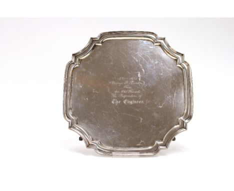 A George V silver pie crust border tray, with presentation inscription, raised on scrolled feet, Sheffield 1930, 34.5cm overa