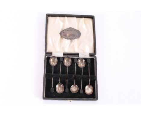 A cased set of silver bean end coffee spoons; and a silver decanter label "Port"