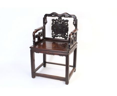A Chinese hardwood throne chair, having shaped top rail above a carved and pierced back panel, raised on square section suppo