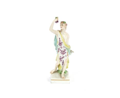 A 19th Century porcelain figure, depicting the goddess of wine, raised on a square platform plinth, 21.5cm high