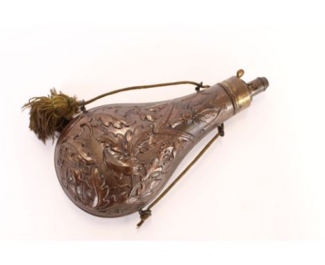 A Hawksley copper powder flask, of large size, profusely decorated with oak leaves and stags head, hung to a tasselled cord, 