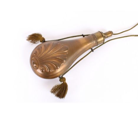 A large Hawksley copper shell pattern powder flask, hung to a tasselled cord, 25.5cm