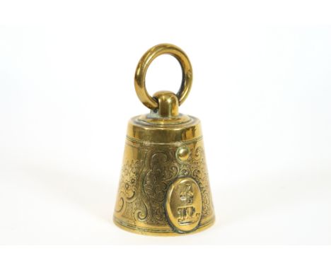 A brass novelty inkwell, in the form of a miniature weight, 9cm high