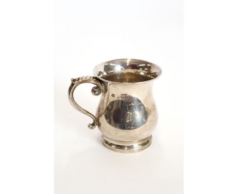 A silver  baluster shape mug, by William Adams, Birmingham 1914, having leaf capped scroll handle, 5ozs., 9cm