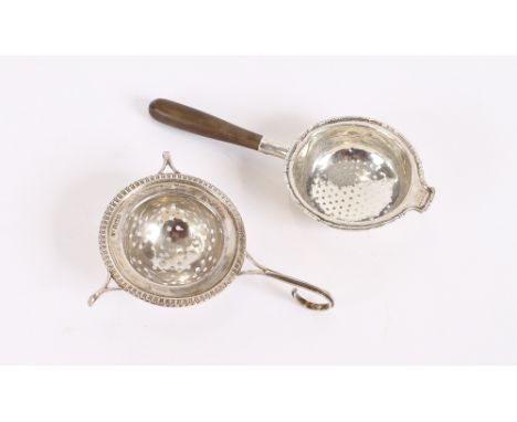 A silver tea strainer, Birmingham 1919; and another similar with turned wooden handle (2)