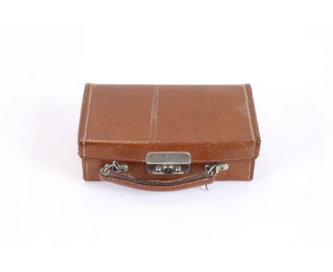 A miniature leather suitcase and contents, to include a silver watch chain with attached coin fob, seven small brass cuff-lin