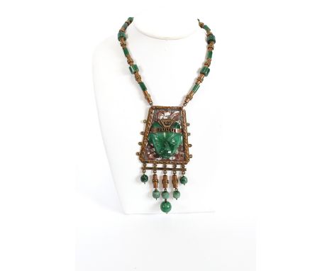 A Mexican carved jade and gilt metal pendant