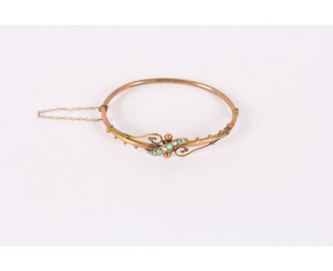 A hinged 9ct gold bangle, with foliate embossed decoration and buckle clasp; another set seed pearls and turquoise; another p