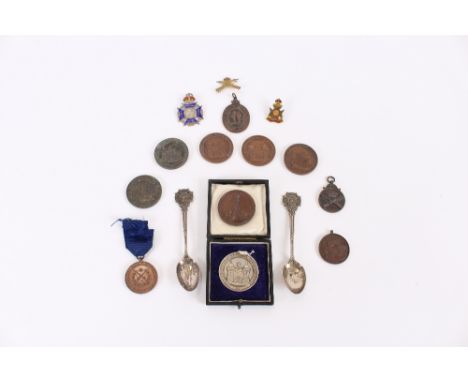 A silver Suffolk Rifle medal; 13 copper and bronze others; a white metal and enamel decorated rifle match trophy, dated 1927;