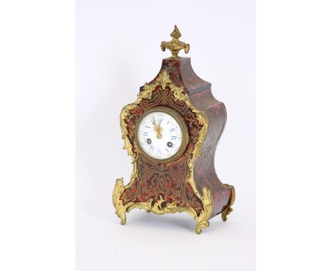 A French tortoise shell, brass inlaid and gilt metal mounted mantel clock, in the manner of Boulle, having 8 day striking mov