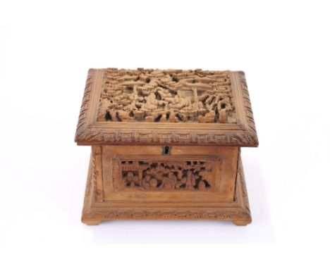 A Chinese carved hardwood trinket box, profusely decorated figures in relief amongst trees and foliage, 18.5cm wide