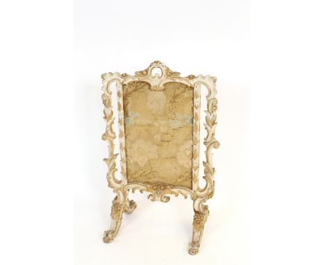 A 19th Century painted and gilt decorated fire screen, with silk embroidered panel, surrounded by pierced foliate scrolls, 62