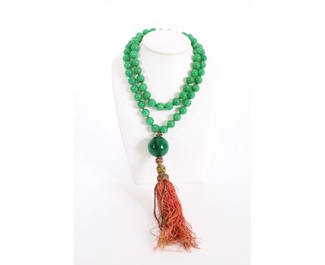 A long green jade necklace, with tassel pendant