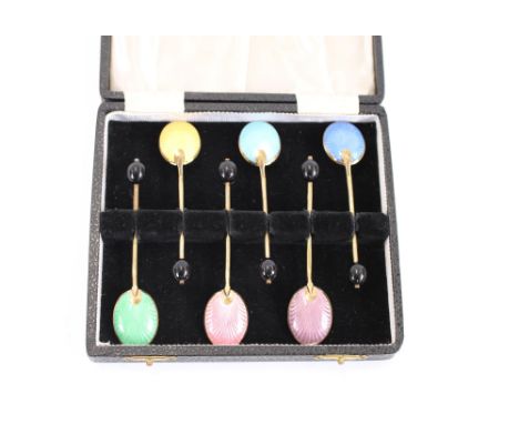 A cased set of six silver gilt and enamel bean end coffee spoons