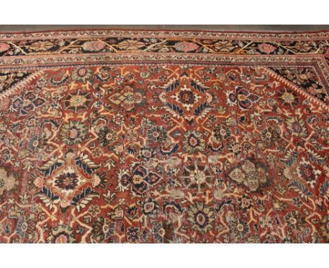 A large Mahal carpet, having allover stylised floral decoration within multi borders on a predominately red ground, approx. 4