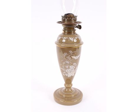 A Victorian brown opaque table oil lamp, with white raised foliate and bird decoration, 64.5cm high overall