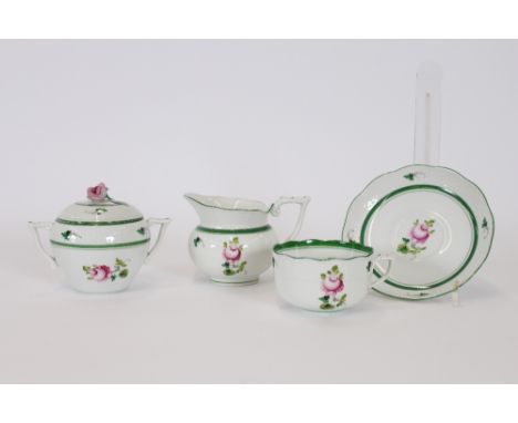 A set of four Herend rose decorated tea cups and saucers, together with a matching cream jug and covered sucrier