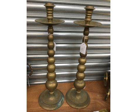 A pair of late 19th Century brass candlesticks, originally from Donisthorpe Chapel, Leicestershire, the columns of bobbin des