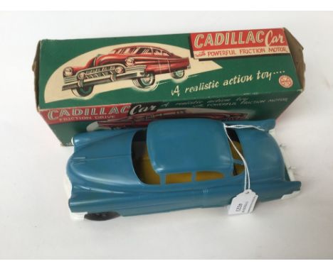 Marx: A boxed Cadillac Friction Drive Car, 'A realistic action toy with Powerful Friction Motor', blue car, yellow base. (1)