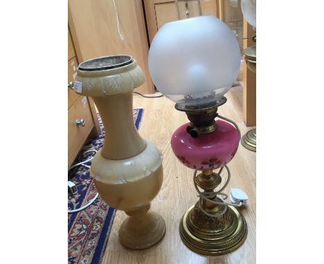 An electrified oil lamp, brass base, pink glass reservoir, shade and chimney; together with an alabaster stand (2) 