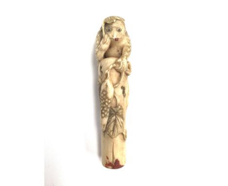An early 19th Century carved ivory walking stick handle, mythical monkey on top of a tree stump 