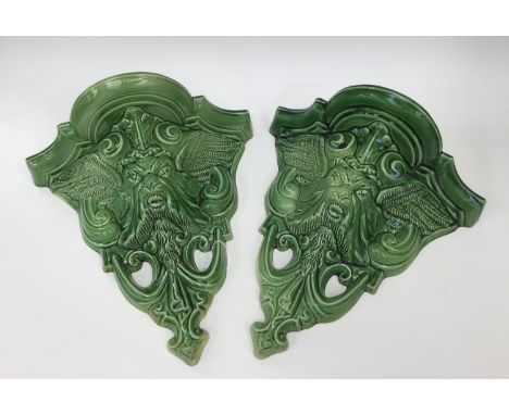 A pair of ceramic green man wall pockets. (2) 