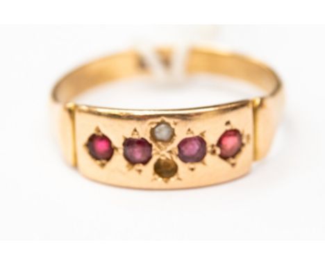 An 18ct gold circa 1910 ruby and seed pearl band, one pearl missing, size O, with a total gross weight approx 3gms 