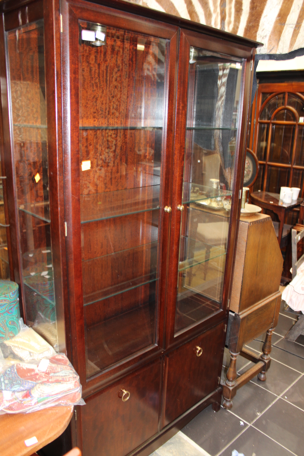 A pair of Stag display cabinets, each fitted with two doors, enclosing ...