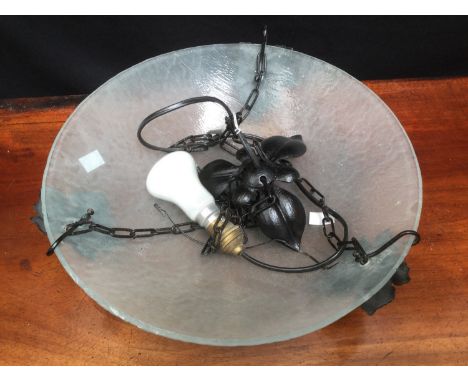 A glass ceiling light with cast metal holders