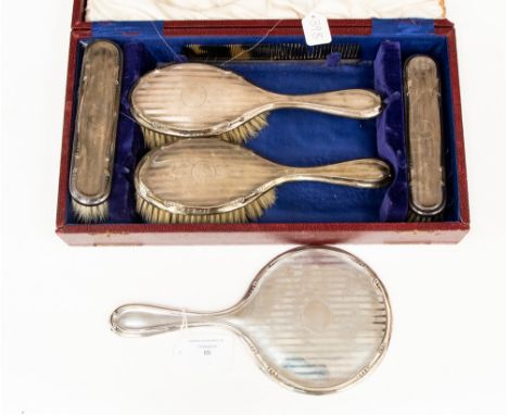 A silver mounted five piece dressing table set, by Bravingtons Ltd, Birmingham 1923, to include a pair of hair brushes, a pai