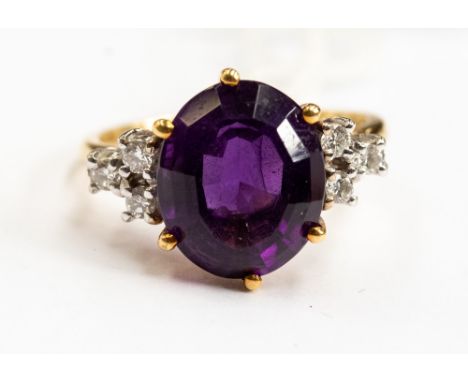 An amethyst and 18ct gold diamond dress ring, comprising an oval amethyst approx 12mm x 9mm, with claw set diamond shoulders,