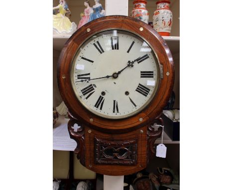 A late 19th Century walnut eight day wall clock, the white enamelled dial with black Roman numerals and two winder holes, wit