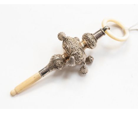 A novelty silver rattle by Crisford & Norris, Birmingham 1924, the hollow silver rattle fashioned as a baby holding circular 