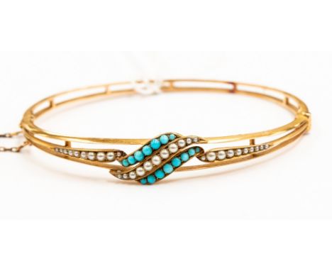 A yellow metal seed pearl and turquoise bangle, probably 14ct, with cross over turquoise and seed pearl set design, inside di