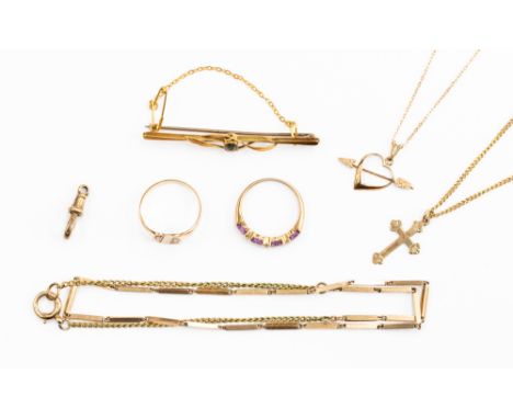 A collection of 9ct gold and yellow metal jewellery, including a stone set bar brooch, amethyst set ring, a 9ct gold cross an