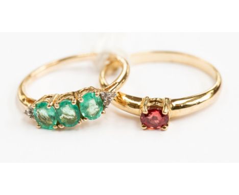 A 9ct gold ruby ladies dress ring, ring size T½; together with an emerald and diamond dress ring, ring size O, with a combine