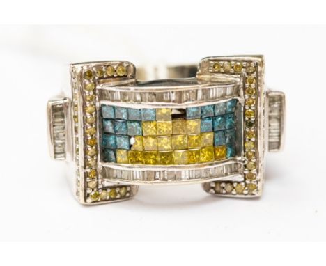 A large blue, yellow and white diamond dress ring, set in 14ct white gold, in the style of a buckle, rows of princess cut yel