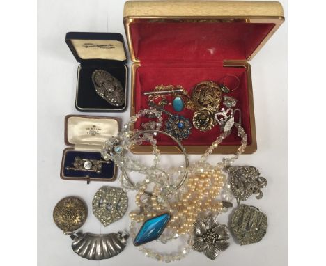 A collection of costume jewellery to include a silver and paste arts and crafts gilt metal brooch a paste set vintage brooch,