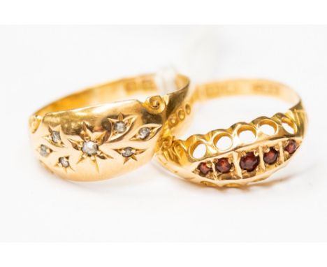 Two circa 1900 18ct gold stone set rings, one set with diamond chips the other a ruby boat head ring, sizes N and O, with a c