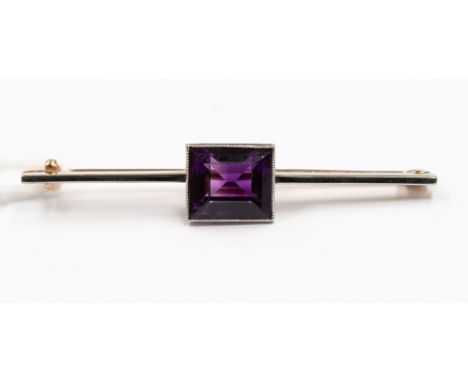An amethyst bar brooch, a square set amethyst approx size 8mm x 8mm, set in white metal possibly platinum with rose metal pin