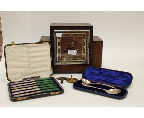 A 1940s oak cased mantel clock, key and pendulum, plus two cased EPNS flatware (3) 